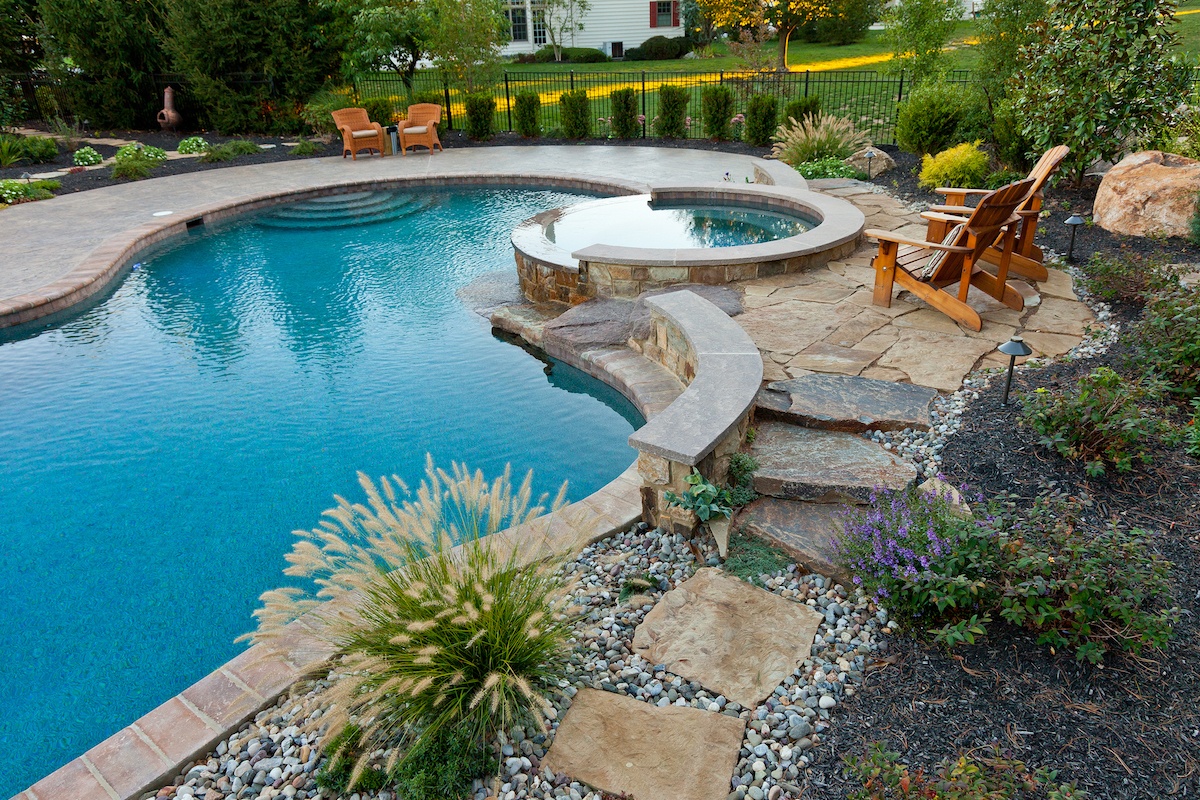 low maintenance landscape and pool design with stones