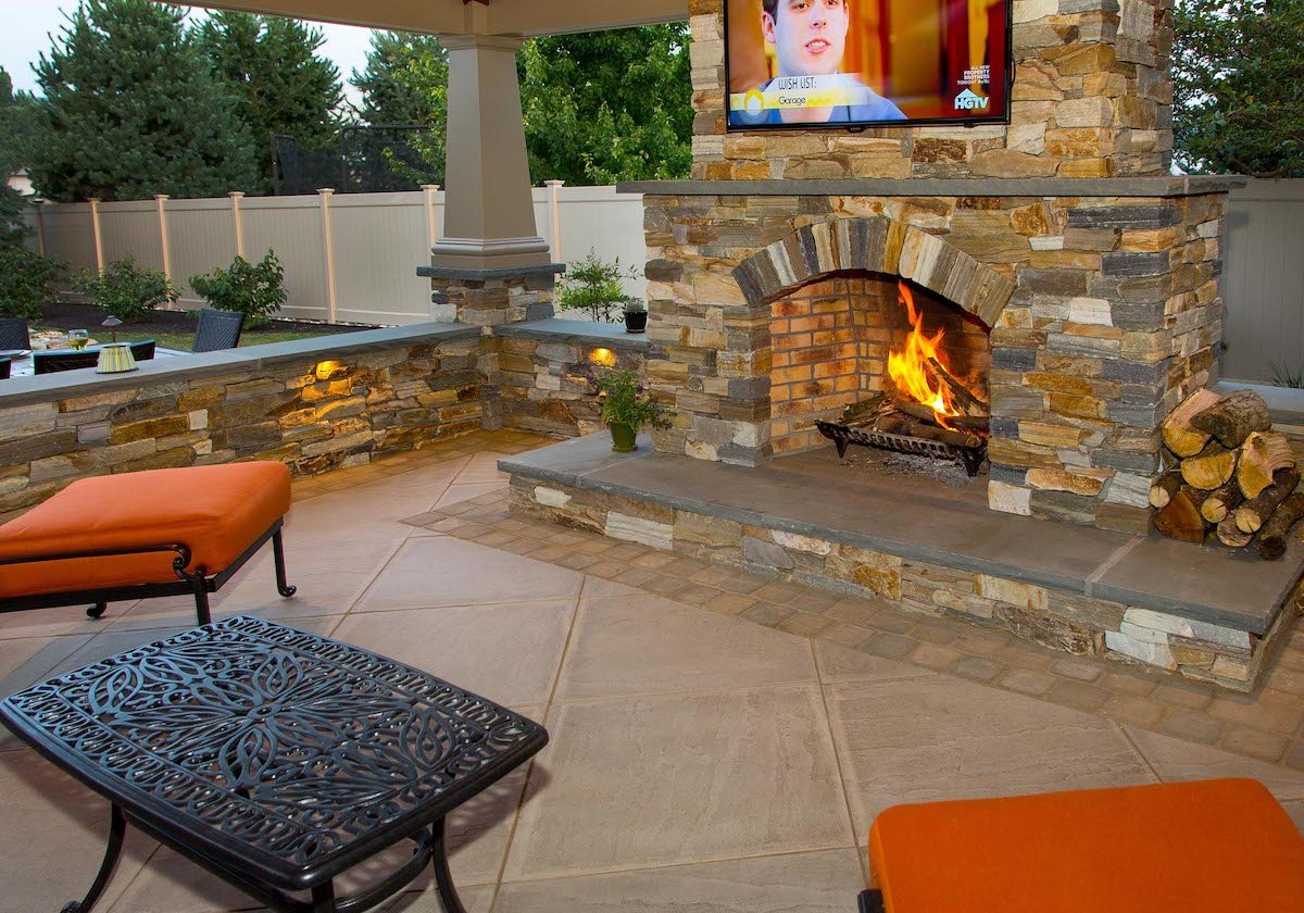 Natural stone outdoor fireplace with television in New Holland, PA
