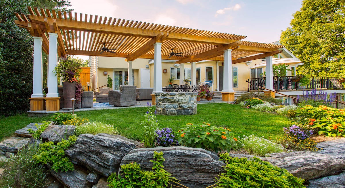 Landscape with pergola, plants, and fire pit in Leola, PA