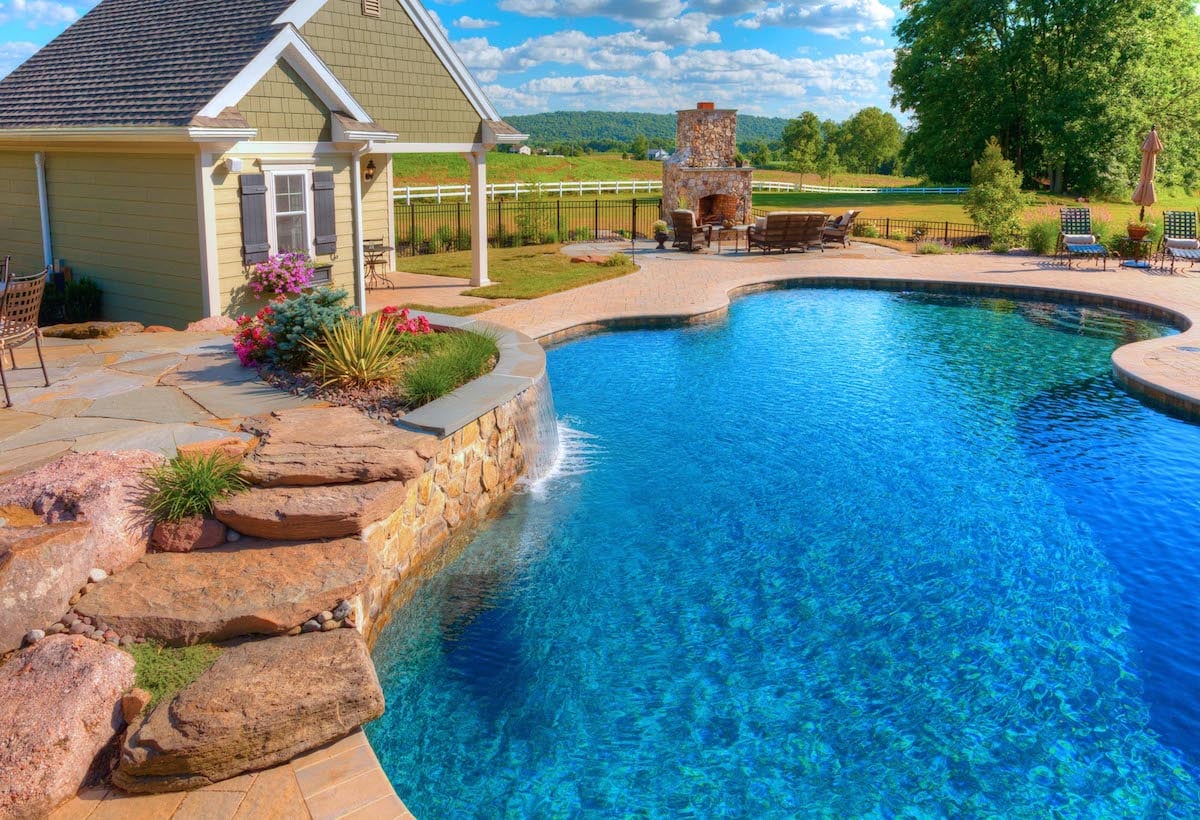 Pool with pool house and outdoor fireplace in Lancaster, PA