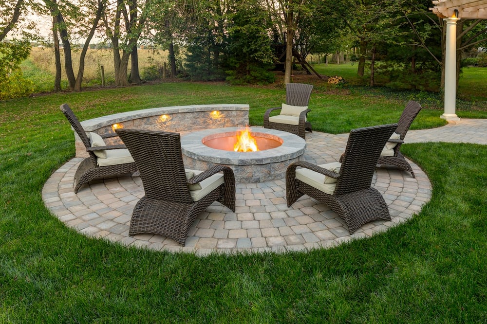 round fire pit with lighting in lawn